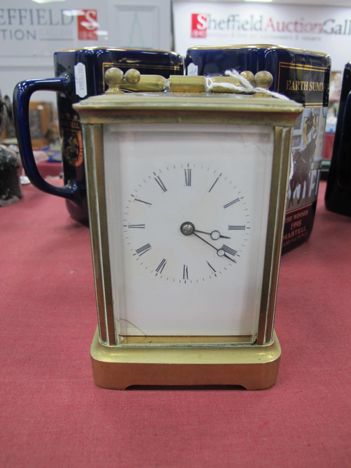 A Brass Carriage Clock, with carrying handle (cracks to face).