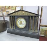 A XIX Century Black Slate Mantel Clock, brass pediment, decorated with figures, circular dial, brass