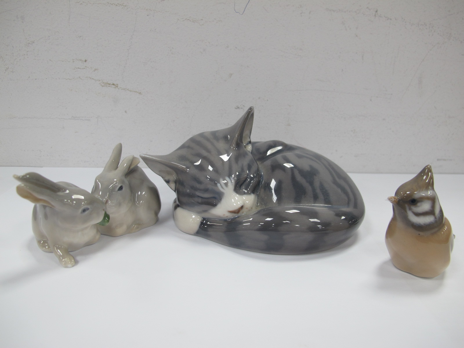 Royal Copenhagen Model of a Sleeping Cat, number 422, rabbits group 1252, 518 and bird 1506. (3).