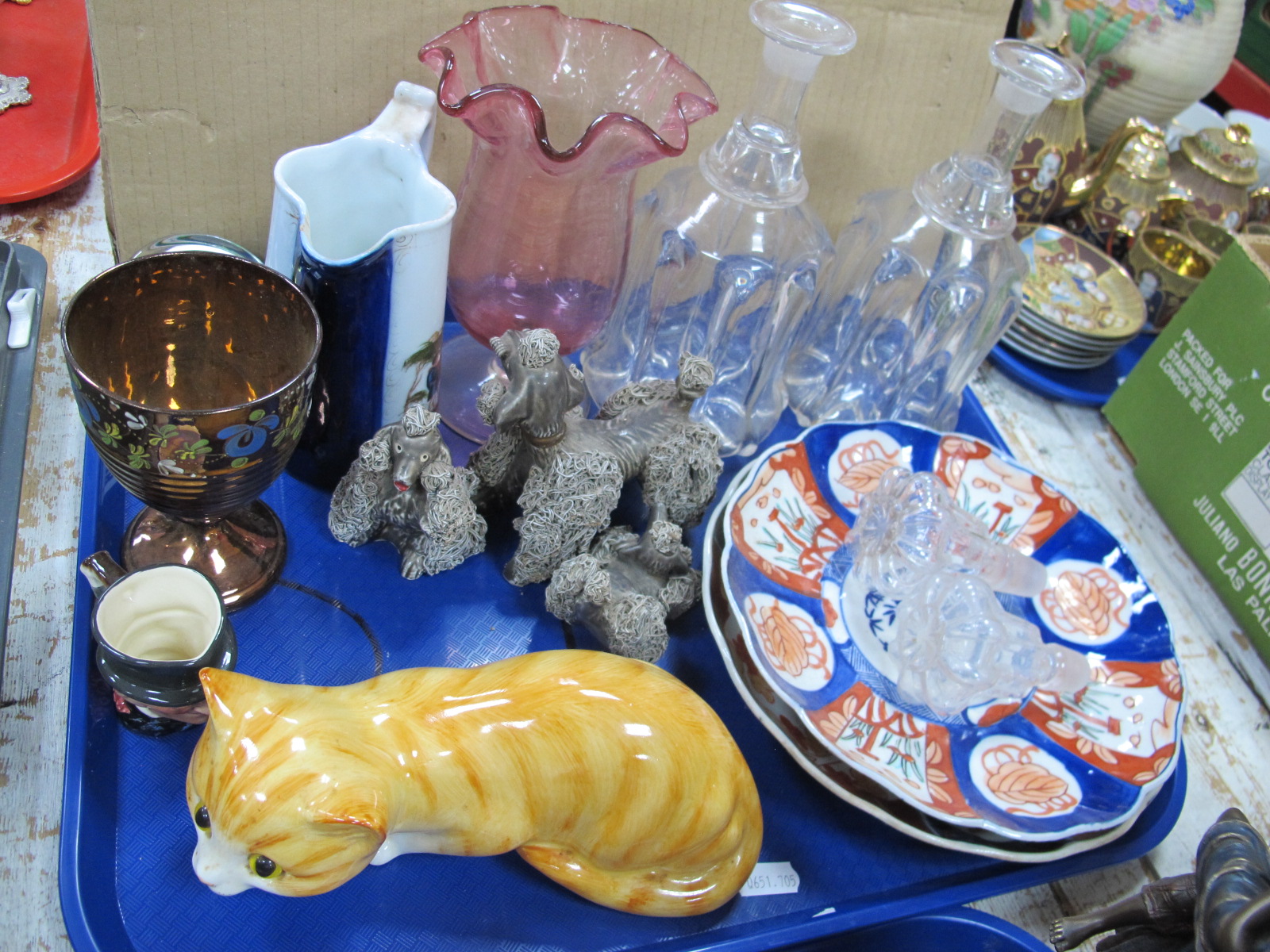 A Pair of Mallet Shaped Glass Decanters, Imari plates, Cranberry vase, pottery cat, etc:- One Tray.