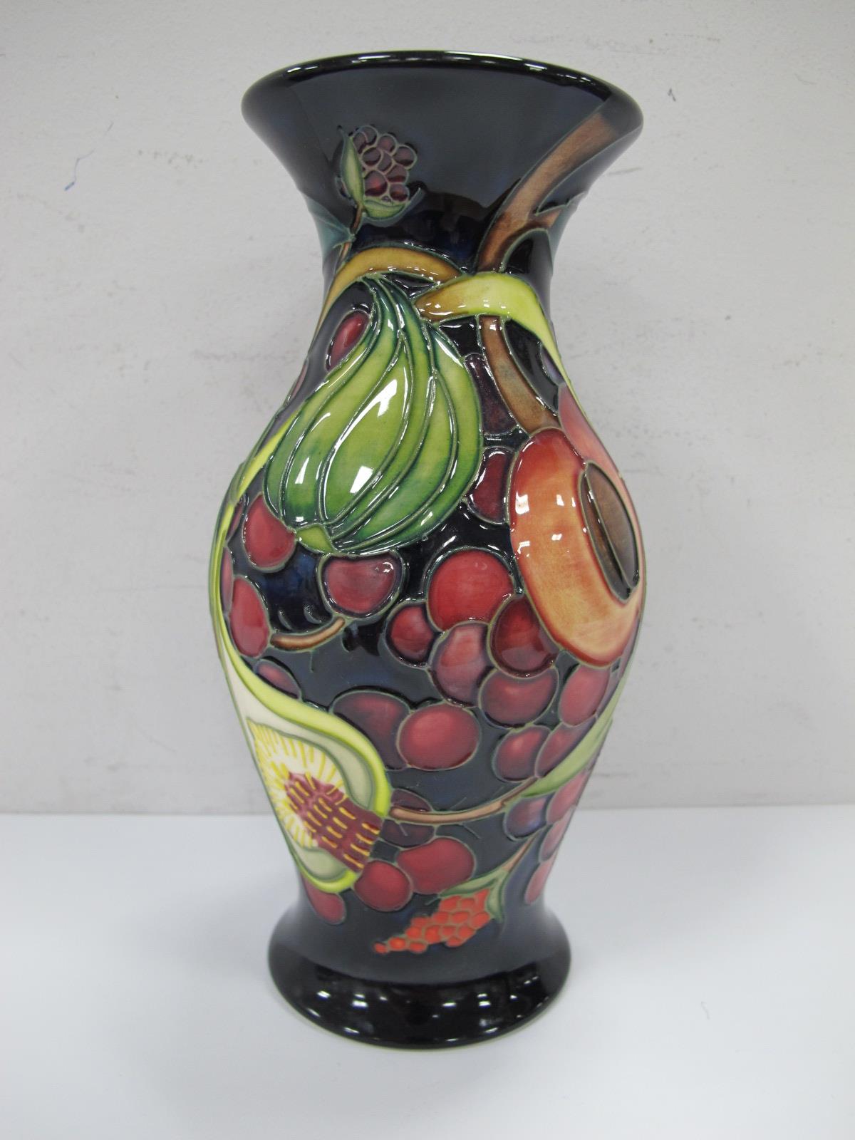 A Moorcroft Vase, with blue ground decorated with fruit, with green mark on base, Moorcroft (L) 2000