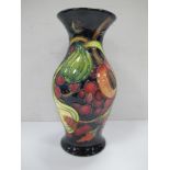 A Moorcroft Vase, with blue ground decorated with fruit, with green mark on base, Moorcroft (L) 2000