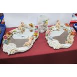 A Pair of Continental Porcelain Wall Mirrors, decorated figures and floral decoration, together with