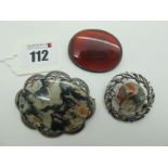 A Moss Agate Oval Panel Brooch, within shaped pierced setting, stamped "Silver"; together with a