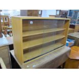 A Lightwood Bookcase, with glazed sliding doors, 101 cm wide.