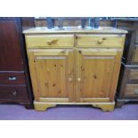 Pine Cabinet The Top, with a moulded edge, two small drawers, twin panelled cupboard doors, on