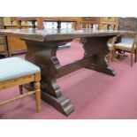 An Oak Refectory Table, on shaped trestle supports, united by a stretcher, 180cm wide.