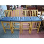 A Set of Four High Bar/Kitchen Chairs, in light wood with blue padded seats.