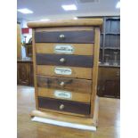 A Four Drawer Pine Table Top Cabinet with Apothecary Labels, 40cm high.