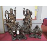 A Pair of Carved Oriental Hardwood Figures, together with two other hardwood figures of a boy on