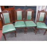 A Set of Four Early XX Century Oak Chairs, with a shaped top rail, with swag decoration, upholstered