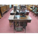 A Singer Treadle Sewing Machine, with accessories in two drawers.