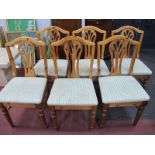 A Set of Eight Ducal Pine Dining Chairs, shaped top rail, pierced splats, upholstered seats, on