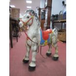 A XX Century MOBO Bronco Painted Ride on Horse, 68cm wide.
