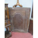 An XVIII Century Oak Corner Cupboard, with arched door, 111cm high.