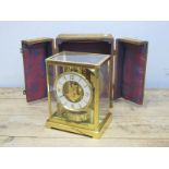 A Jaeger Le Coultre Atmos Clock, in brass and glass panelled case, the circular white chapter ring