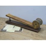 An E Dent and Co Ltd Inclined Plane Mahogany and Brass Gravity Time Piece, the 10cm diameter dial