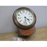 An Early XX Century Oak Cased Railway Style Clock, the white enamel dial with Arabic numerals 1-12