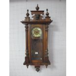A Late XIX Century Walnut Cased Vienna Wall Clock, the white dial, with Roman numerals, carved