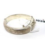 A Hallmarked Silver Hinged Bangle, leaf engraved to the front, hinged to snap clasp (Birmingham