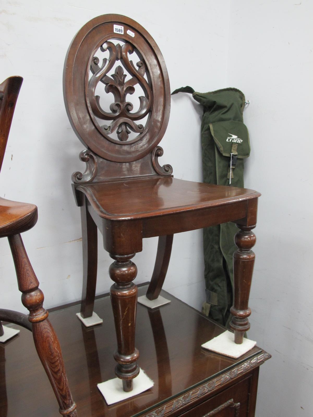 A XIX Century Mahogany Hall Chair, with a oval back,m pierced back with C scroll decoration, solid