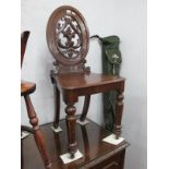 A XIX Century Mahogany Hall Chair, with a oval back,m pierced back with C scroll decoration, solid