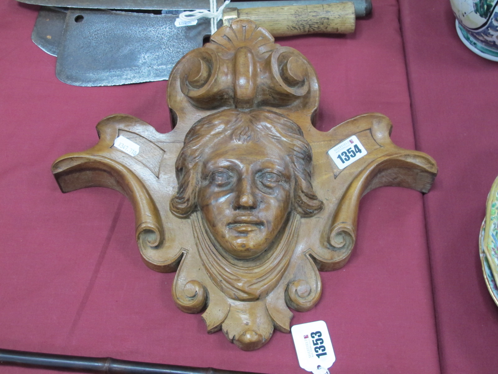 A XIX Century Carved Walnut Wall Hanging with Mask Head, within scroll and shell surround, 37cm