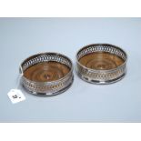 A Pair of Hallmarked Silver Bottle Coasters, C.J. Vander, London 1963, each with turned wood base,
