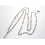 A Long Moonstone Necklace, of graduated design, spectacle set, suspending two stone drop.