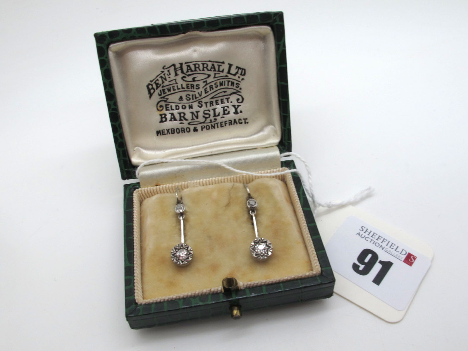 A Pair of Two Stone Diamond Set Drop Earrings, each old cut stone illusion set, on plain bar and