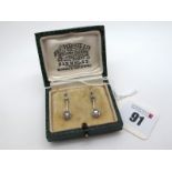 A Pair of Two Stone Diamond Set Drop Earrings, each old cut stone illusion set, on plain bar and