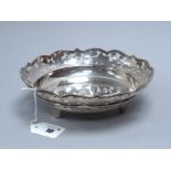 A Chinese Dish, of circular form, within shaped pierced border, raised on three tapering feet,