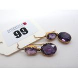 A Pair of Amethyst Two Stone Drop Earrings, graduated oval collet set, on hook fittings.