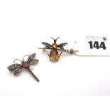 A Citrine Inset Insect Brooch, with claw set body and inset wings, on knife edge bar (3.7cm long);