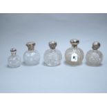 Five Hallmarked Silver Mounted Globular Glass Scent Bottles, (various makers and dates) (damage). (