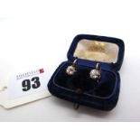 A Pair of Single Sone Diamond Earstuds, each old cut stone claw set on simple hook fitting,