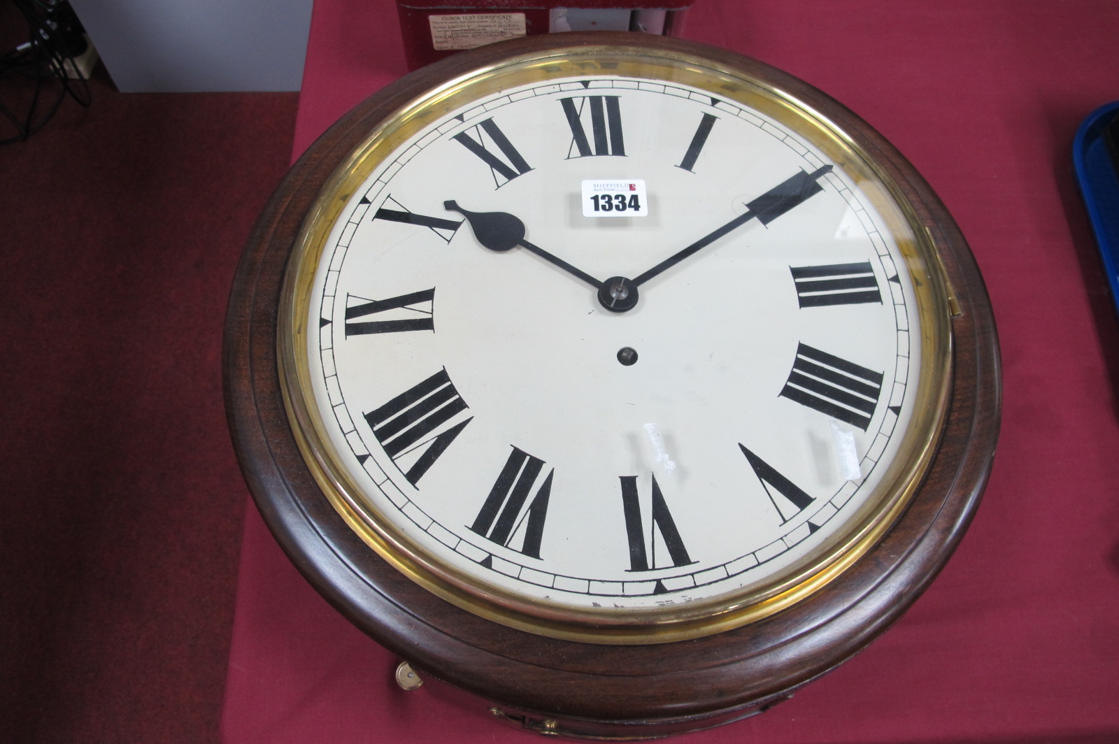 A Railway Style Clock, the mahogany circular case, with white enamel dial, with Roman numerals,