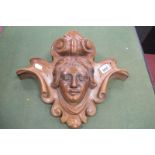 A XIX Century Carved Walnut Wall Hanging with Mask Head, within scroll and shell surround, 37cm