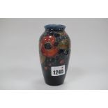 A Moorcroft Pottery Pomegranate Design Vase, of ovoid form, with blue ground, Moorcroft signature
