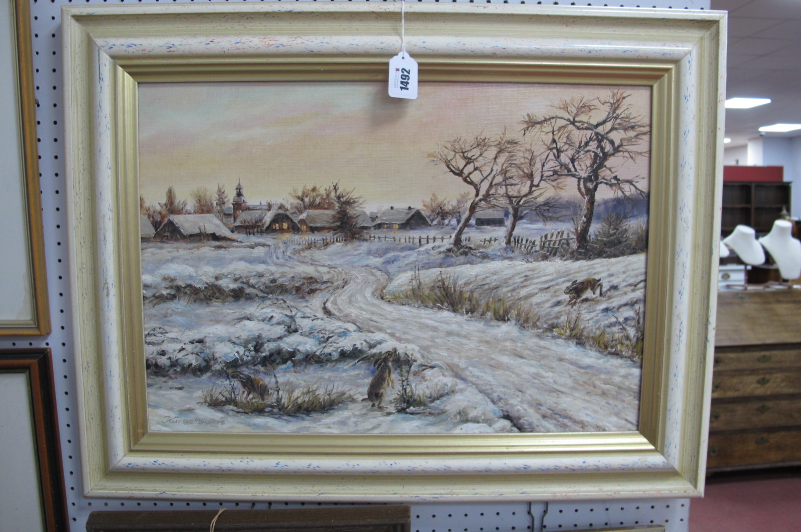XX Century German School, Hares Feeding in a Snow Covered Landscape, on the edge of a village at