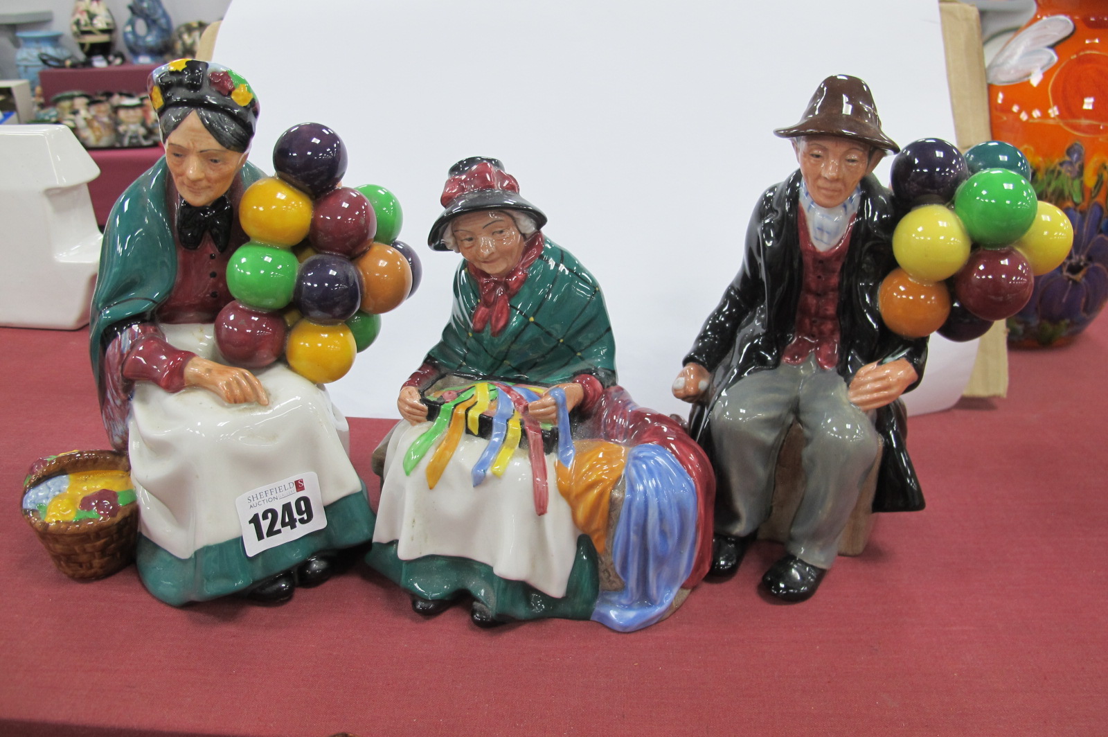 Royal Doulton Figurines 'The Old Balloon Seller', 'The Balloon Man' and 'Silks and Ribbons'. (3)