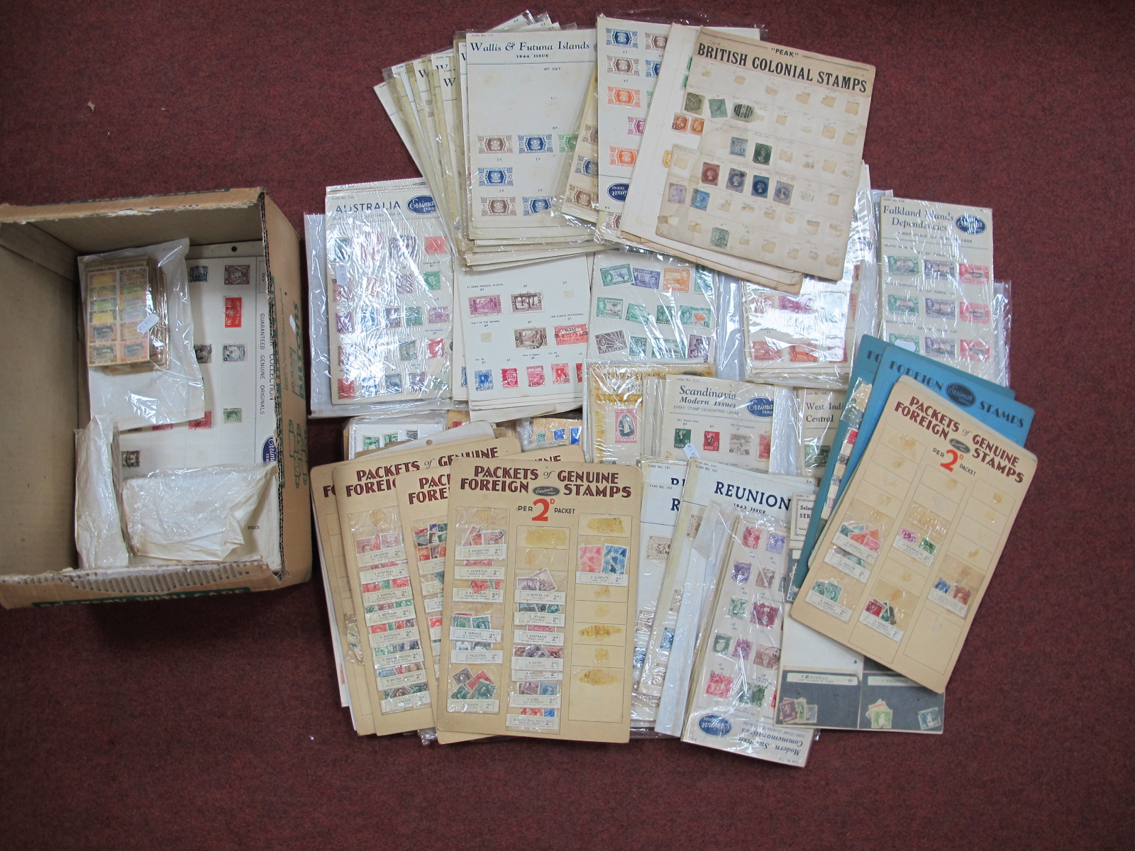 A Box Containing a Large Quantity of Stamps, in early vendors packets, on cards, etc, contains a mix