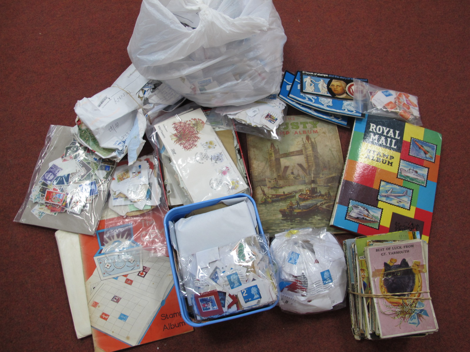 A Large Box of Stamps, in albums plastic tubs and bags, FDC's and postcards.