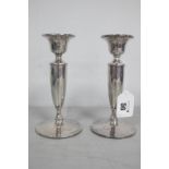 A Pair of Hallmarked Silver Candlesticks, Birmingham 1919, each of plain design, with tapering stem,