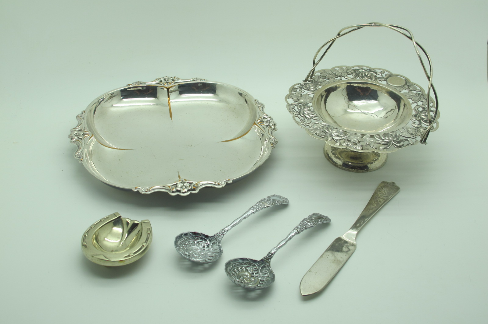 A Decorative Pedestal Dish, with openwork handle (detached); together with a pair of plated sifter