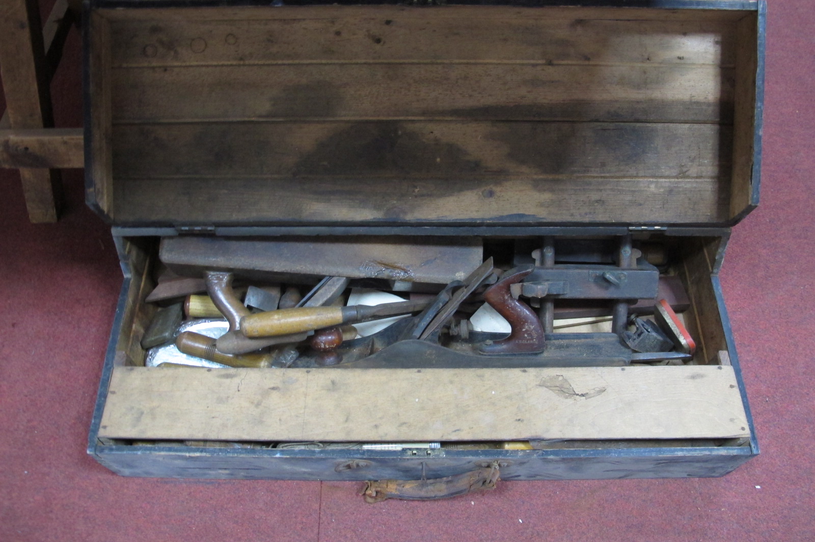 Chisel's, planes, other tools, in a tool box.