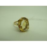 A 9ct Gold Citrine Single Stone Dress Ring, oval claw set, high within pierced setting (finger