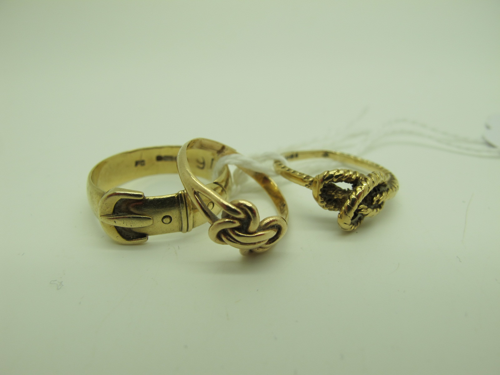 A 9ct Gold Band, of belt buckle design (finger size Q); together with two further 9ct gold rings (