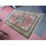 A Middle Eastern Silk Rug, with a central foliate medallion, with salmon pink ground, surrounded