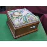 A XIX Century Oak Footstool/Workbox, with later tapestry top and lift-up lid, on bun feet.